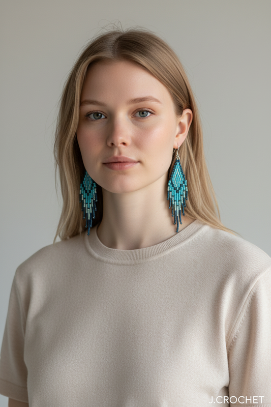 J.CROCHET handcrafted beaded tassel earrings in ocean teal, turquoise, and navy blue glass beads with hook closures.